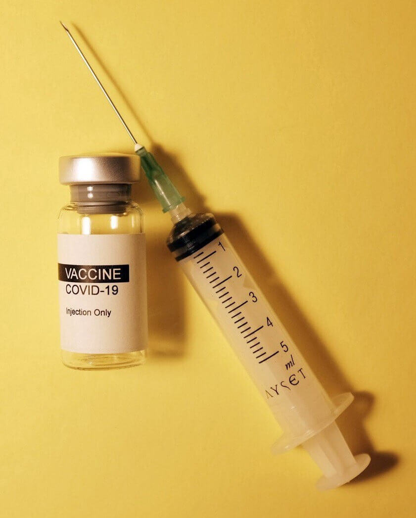 Vial labeled Vaccine COVID-19 injection only and needle / syringe